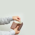 Man holding open leather wallet full of money or paper dollar bills Royalty Free Stock Photo