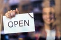 Man holding open sign in bike shop