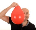 Man holding orange balloon