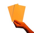 Man holding orange flyers on white background, closeup. Mockup for design Royalty Free Stock Photo