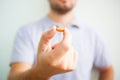 Man holding an orange pill with his fingers Royalty Free Stock Photo
