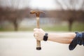 Man holding out an old rusty hammer against a blurry background Royalty Free Stock Photo