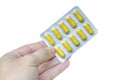 Man holding pack of yellow pills Royalty Free Stock Photo