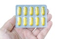 Man holding pack of yellow pills Royalty Free Stock Photo