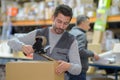 Man holding packing machine and sealing cardboard boxes Royalty Free Stock Photo