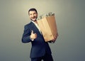 Man holding paper bag with money Royalty Free Stock Photo