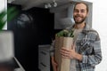 Man holding paper grocery shopping bag full of fresh healthy food vegetables in his hand. Royalty Free Stock Photo