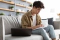 Man holding paper, writing and working on laptop at home Royalty Free Stock Photo