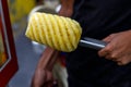 A man holding a peeled pineapple