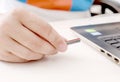 Man holding pen device in hand with laptop on table Royalty Free Stock Photo