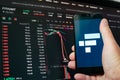Man holding phone with FTX logo. Global fall of cryptocurrency graph - FTT token fell down on the chart crypto exchanges