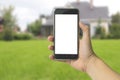 Man holding phone, right hand mockup in park outdoors, has green wood background,  screen insert display Royalty Free Stock Photo