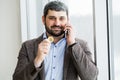 Man holding phone - young businessman using smartphone in office Royalty Free Stock Photo