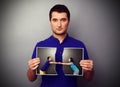 Man holding the photo of young couple