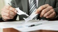 A man is holding a piece of paper that has been torn in half Royalty Free Stock Photo