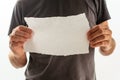 Man holding piece of torn blank paper as copy space