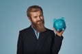 Man holding piggy bank money box over blue Royalty Free Stock Photo