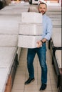 man holding pile of folding mattresses in hands in furniture