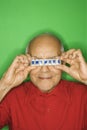 Man holding pill organizer over eyes. Royalty Free Stock Photo