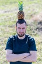 A man holding a pineapple on his head Royalty Free Stock Photo