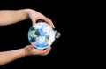 Man holding planet Earth in hands. Eco-friendly concept.  Environment protection. Save nature idea. Isolated on black background Royalty Free Stock Photo