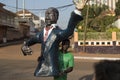 Man holding a plastic figurine of a polititian during the Carnival celebrations in the city of Bisssau.