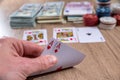 Man holding play card. poker chips