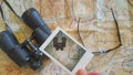 Man holding polaroid photo over a map