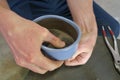 A man holding a pot with wires