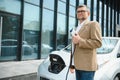 Man holding power connector for electric car Royalty Free Stock Photo