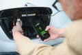 Man holding power connector for electric car Royalty Free Stock Photo