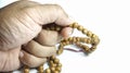 Man holding prayer beads on white background