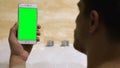 Man holding prekeyed smartphone in bathtub, application for business, template