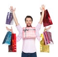 Man holding presents in gift paper bags, isolated on white. Royalty Free Stock Photo