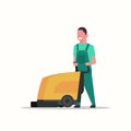 Man holding professional washing machine male cleaner janitor in uniform cleaning service floor care concept flat full
