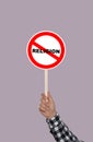 Atheism concept. Man holding prohibition sign with crossed out word Religion on color background Royalty Free Stock Photo