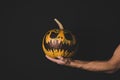 Man holding pumpkin with creepy face