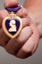 Man Holding Purple Heart War Medal Royalty Free Stock Photo