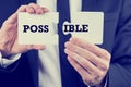 Man holding puzzle pieces with the word Possible