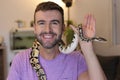 Man holding `python regius` or `ball python` Royalty Free Stock Photo