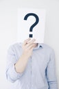 A man holding a question mark in front of head Royalty Free Stock Photo