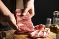 Man holding raw ribs at table, closeup Royalty Free Stock Photo