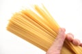 Man holding raw spaghetti italian pasta uncooked spaghetti yellow long ready to cook in the restaurant italian food and menu