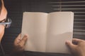 Man holding and reading blank grid notebook