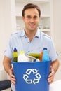 Man Holding Recyling Waste Bin At Home