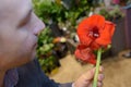 Man holding red amaryllis lily