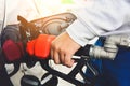 Man holding red fueling nozzle and pumping gasoline fuel fill in car at gas station, car fuels or transportation concept Royalty Free Stock Photo