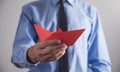 Man holding red origami paper boat Royalty Free Stock Photo