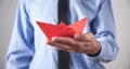 Man holding red origami paper boat Royalty Free Stock Photo