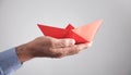 Man holding red origami paper boat Royalty Free Stock Photo